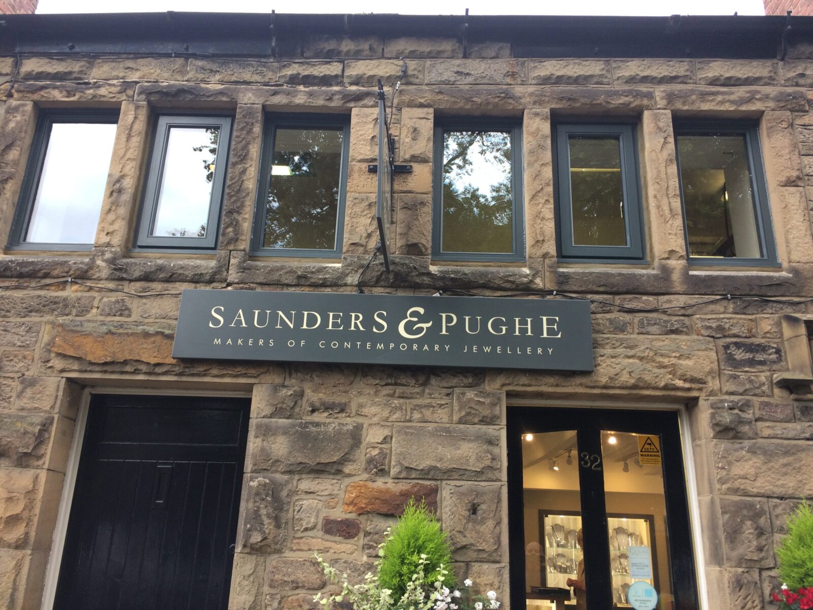 Saunders & Pughe Goldsmiths shopfront, aubergine fascia with antique-gold wordmark, 32 Hill Street, Corbridge